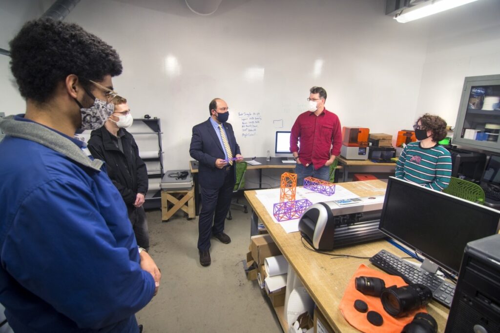 IMRC Center Staff and Students Showcasing the Cube Satellite