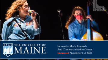 Singer on IMRC Center stage with upright bassist in the background